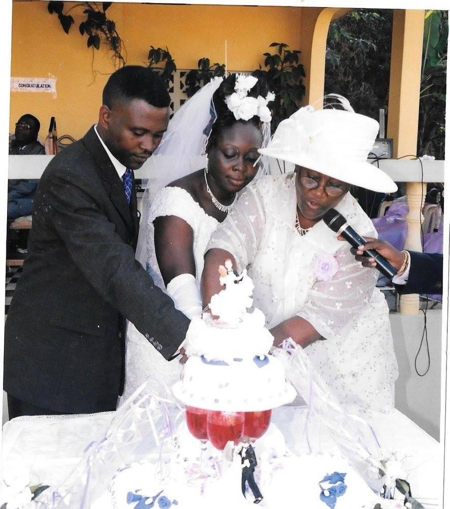 Cutting their wedding cake together